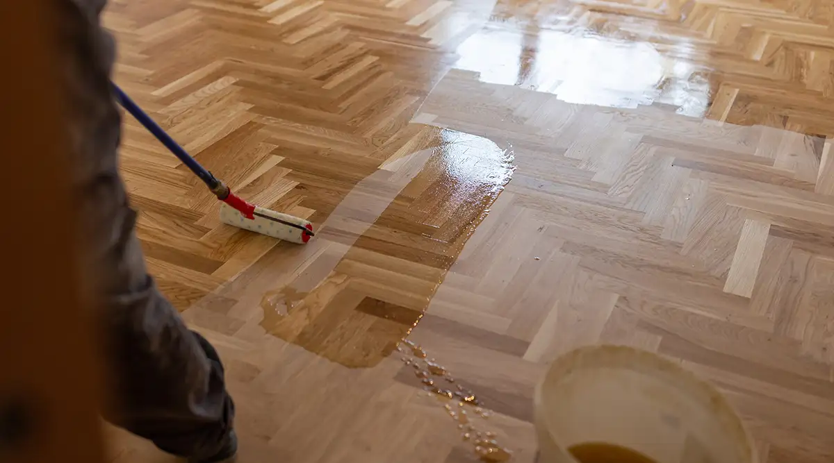 Wood floor being refinished after being sanded